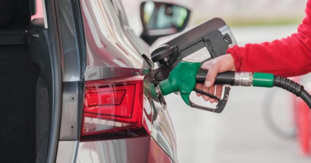 Pumping gas into efficient car at gas station